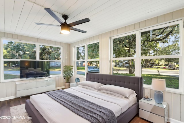 bedroom with ceiling fan and dark hardwood / wood-style flooring