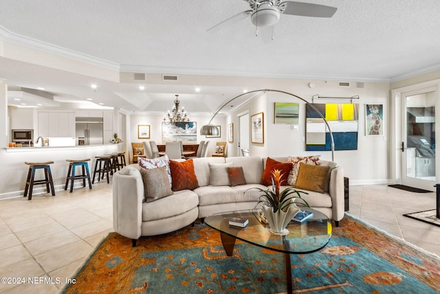 living room featuring a textured ceiling, ceiling fan with notable chandelier, crown molding, and light tile patterned flooring