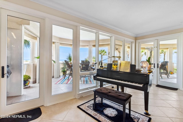 miscellaneous room with light tile patterned floors, crown molding, a wealth of natural light, and french doors