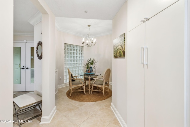 dining area featuring crown molding, french doors, light tile patterned flooring, and an inviting chandelier