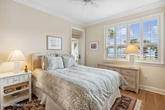 bedroom with ceiling fan, crown molding, and wood-type flooring