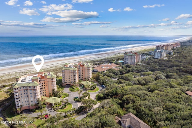 birds eye view of property featuring a view of the beach and a water view