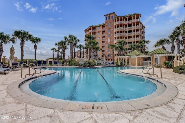 view of swimming pool featuring a patio area