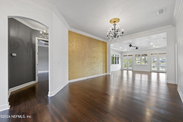 unfurnished living room featuring ceiling fan with notable chandelier, dark hardwood / wood-style flooring, crown molding, and french doors