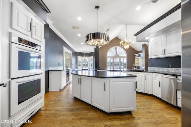 kitchen featuring light wood-type flooring, white double oven, decorative light fixtures, a notable chandelier, and dishwasher