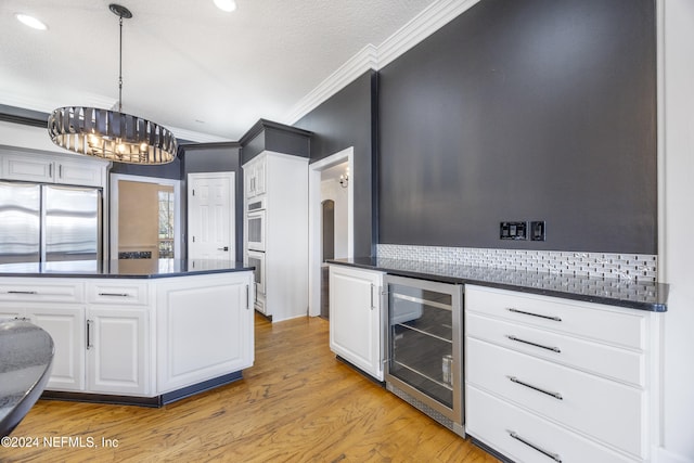 kitchen with stainless steel refrigerator, wine cooler, white cabinets, and light hardwood / wood-style floors