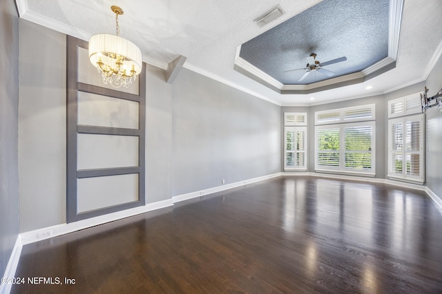 spare room featuring ceiling fan with notable chandelier, hardwood / wood-style flooring, and ornamental molding