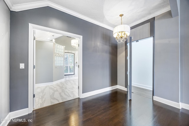 unfurnished room featuring dark hardwood / wood-style flooring, lofted ceiling, crown molding, and an inviting chandelier