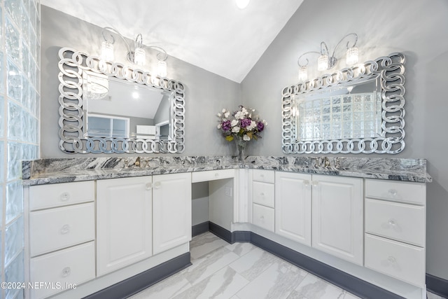 bathroom with vanity and vaulted ceiling