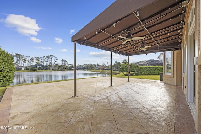 view of patio / terrace with ceiling fan and a water view