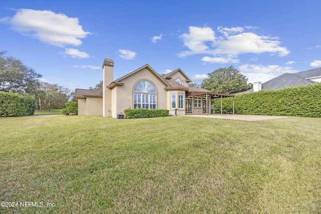 rear view of property featuring a yard