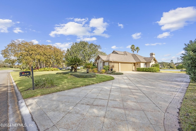 ranch-style house featuring a garage and a front lawn