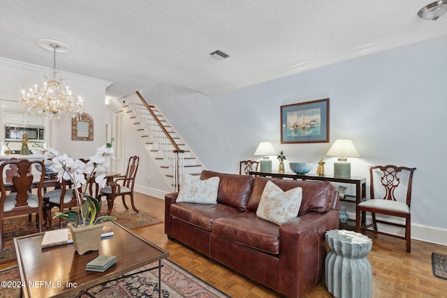 living room with parquet flooring, a textured ceiling, a chandelier, and ornamental molding