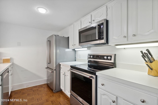 kitchen featuring white cabinets, appliances with stainless steel finishes, and dark parquet floors