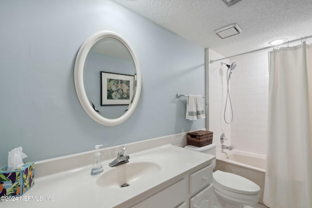 full bathroom featuring toilet, vanity, a textured ceiling, and shower / tub combo with curtain