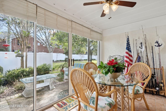 sunroom featuring ceiling fan