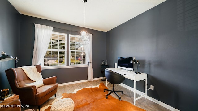 home office with vaulted ceiling and light hardwood / wood-style flooring