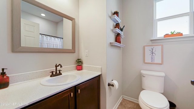 bathroom featuring vanity and toilet