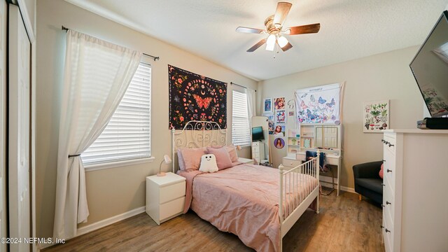 bedroom featuring hardwood / wood-style flooring and ceiling fan