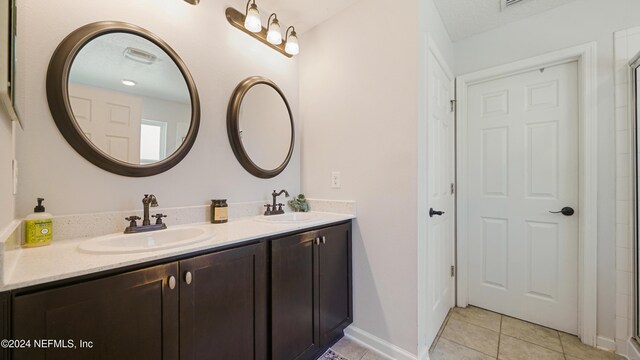 bathroom with tile patterned flooring and vanity