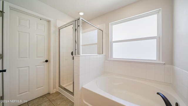 bathroom with plus walk in shower and tile patterned flooring