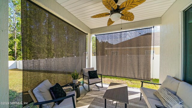 sunroom featuring ceiling fan