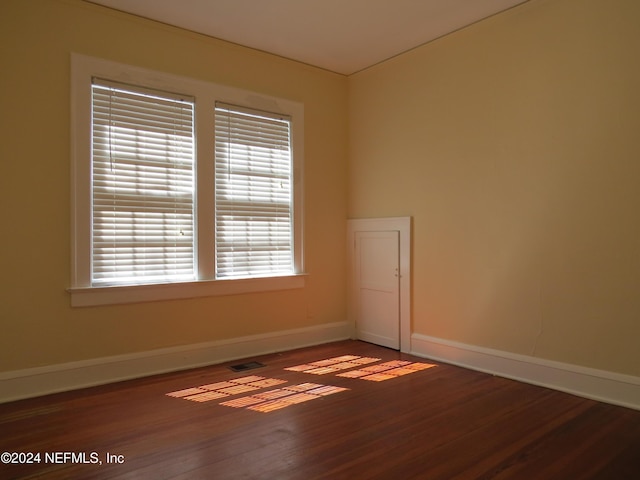 spare room featuring dark hardwood / wood-style flooring