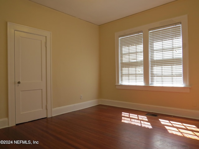 spare room featuring dark hardwood / wood-style floors