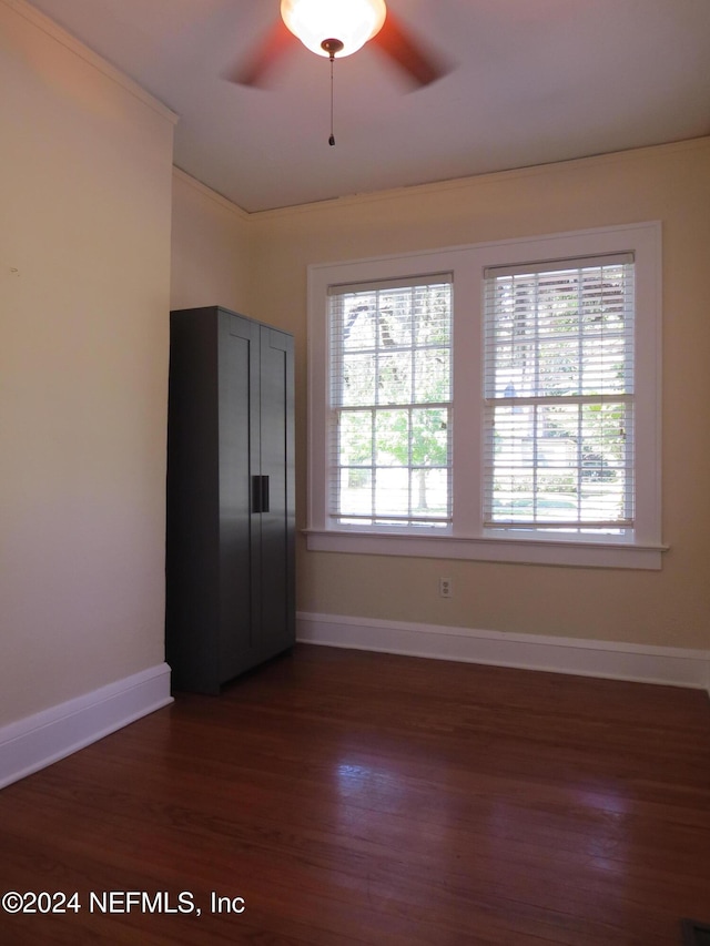 empty room with ceiling fan and dark hardwood / wood-style floors