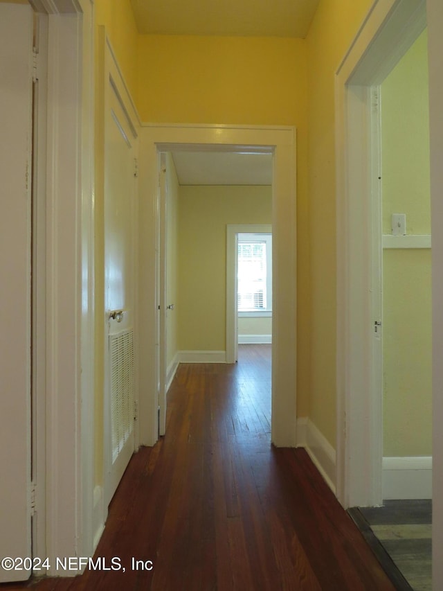 hall with dark hardwood / wood-style flooring