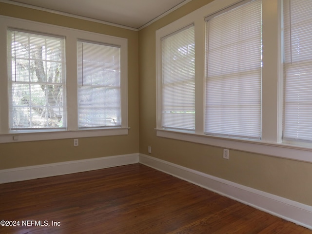 unfurnished dining area featuring crown molding and dark hardwood / wood-style floors