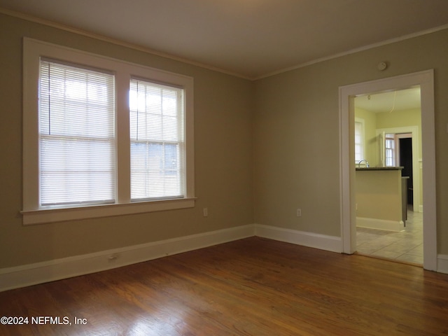 empty room featuring crown molding and dark hardwood / wood-style floors