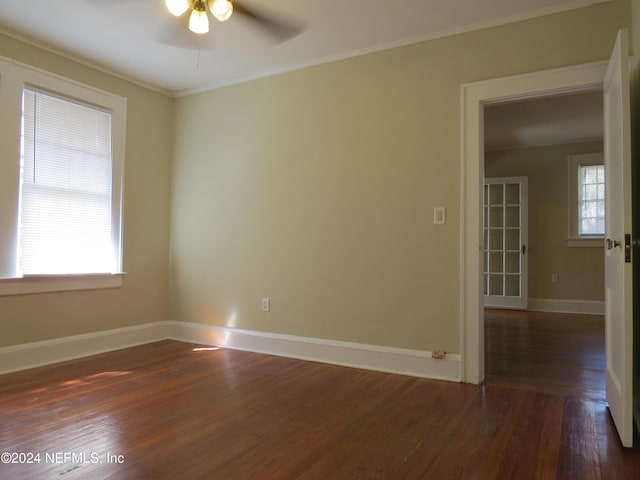 unfurnished room with ceiling fan, plenty of natural light, and dark wood-type flooring