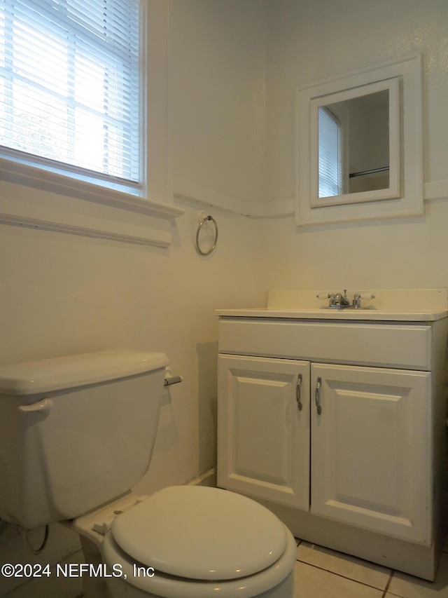 bathroom with tile patterned flooring, vanity, and toilet