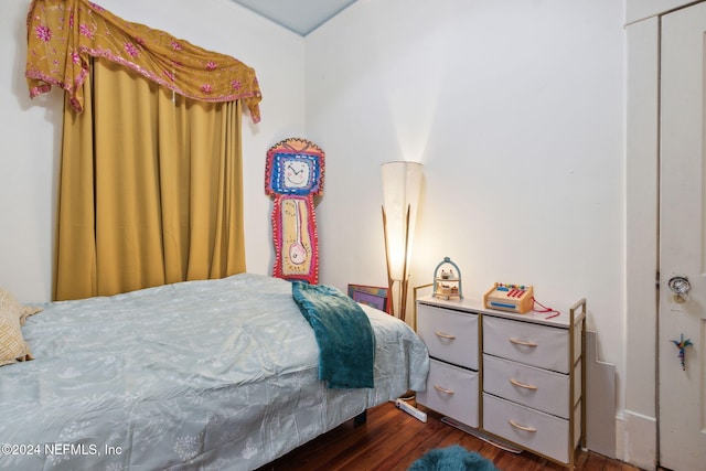 bedroom featuring dark hardwood / wood-style flooring and a closet