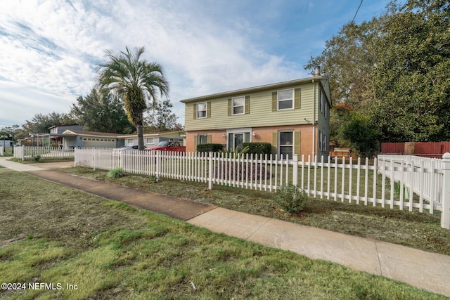 view of front of home featuring a garage and a front yard