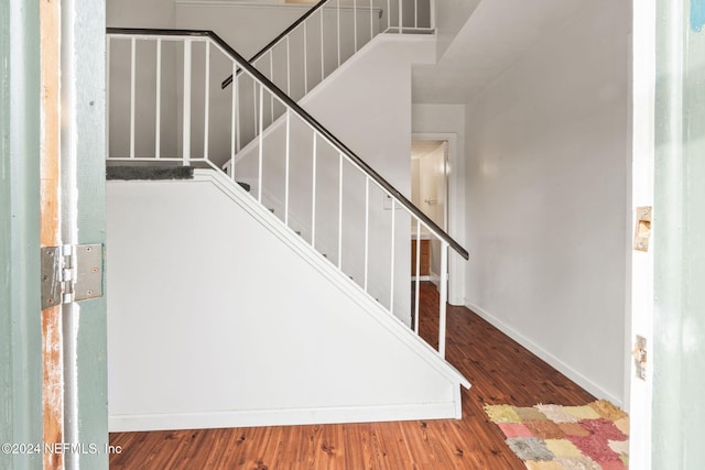 staircase featuring wood-type flooring