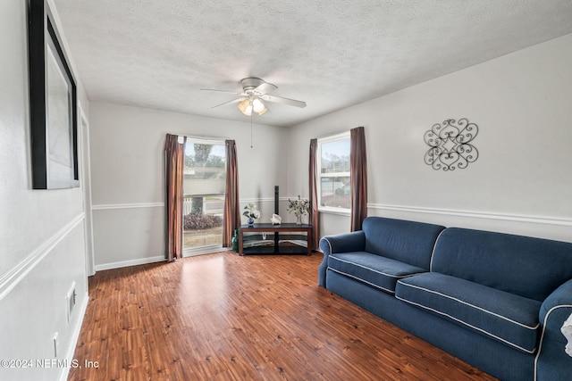 living room with a wealth of natural light, hardwood / wood-style floors, and a textured ceiling