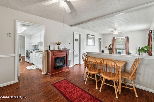 dining room featuring a textured ceiling, dark hardwood / wood-style flooring, and ceiling fan