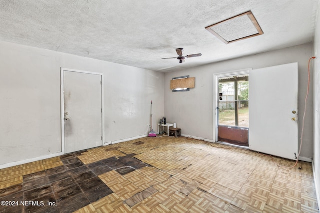 empty room featuring ceiling fan, a textured ceiling, and light parquet flooring