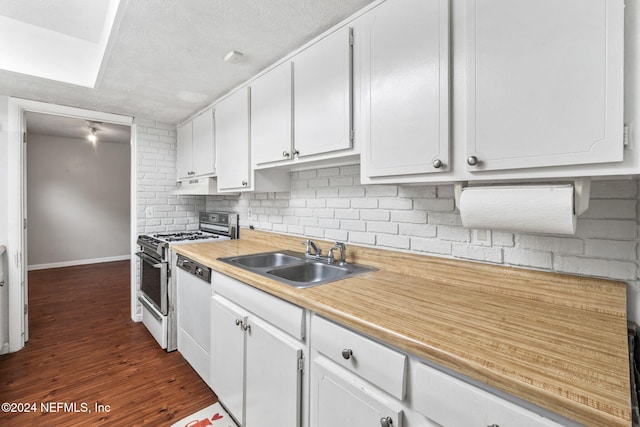 kitchen featuring dark hardwood / wood-style flooring, sink, white cabinets, and white appliances