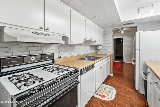 kitchen featuring white appliances, white cabinets, sink, dark hardwood / wood-style floors, and ceiling fan