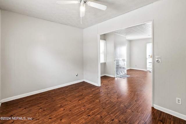 spare room featuring a textured ceiling, dark hardwood / wood-style flooring, and ceiling fan