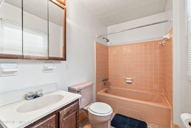 full bathroom with tiled shower / bath combo, toilet, a textured ceiling, and vanity