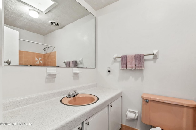 bathroom featuring vanity, a textured ceiling, and walk in shower