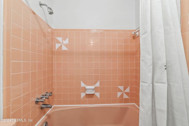 bathroom featuring shower / bathtub combination with curtain