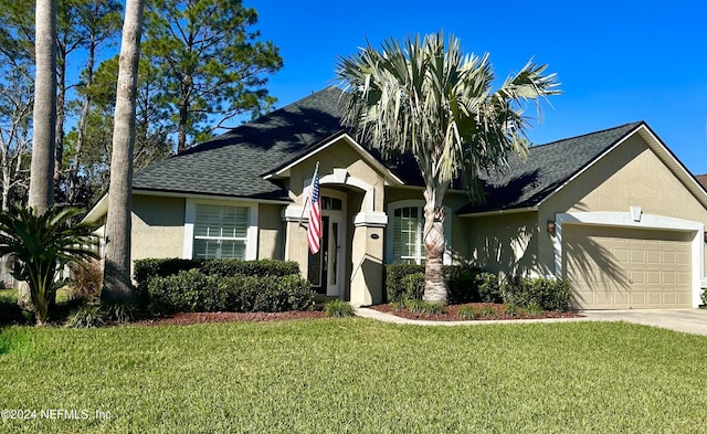 view of front of home with a front lawn and a garage