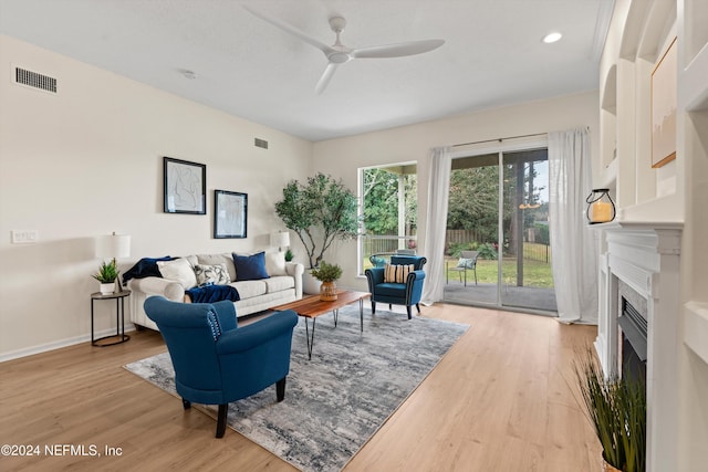 living room featuring ceiling fan and light hardwood / wood-style floors