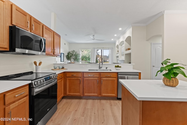 kitchen featuring appliances with stainless steel finishes, ornamental molding, ceiling fan, sink, and light hardwood / wood-style flooring