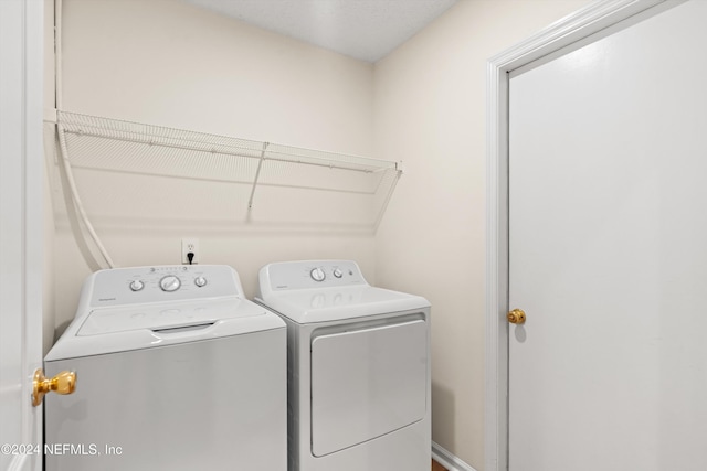 clothes washing area with separate washer and dryer